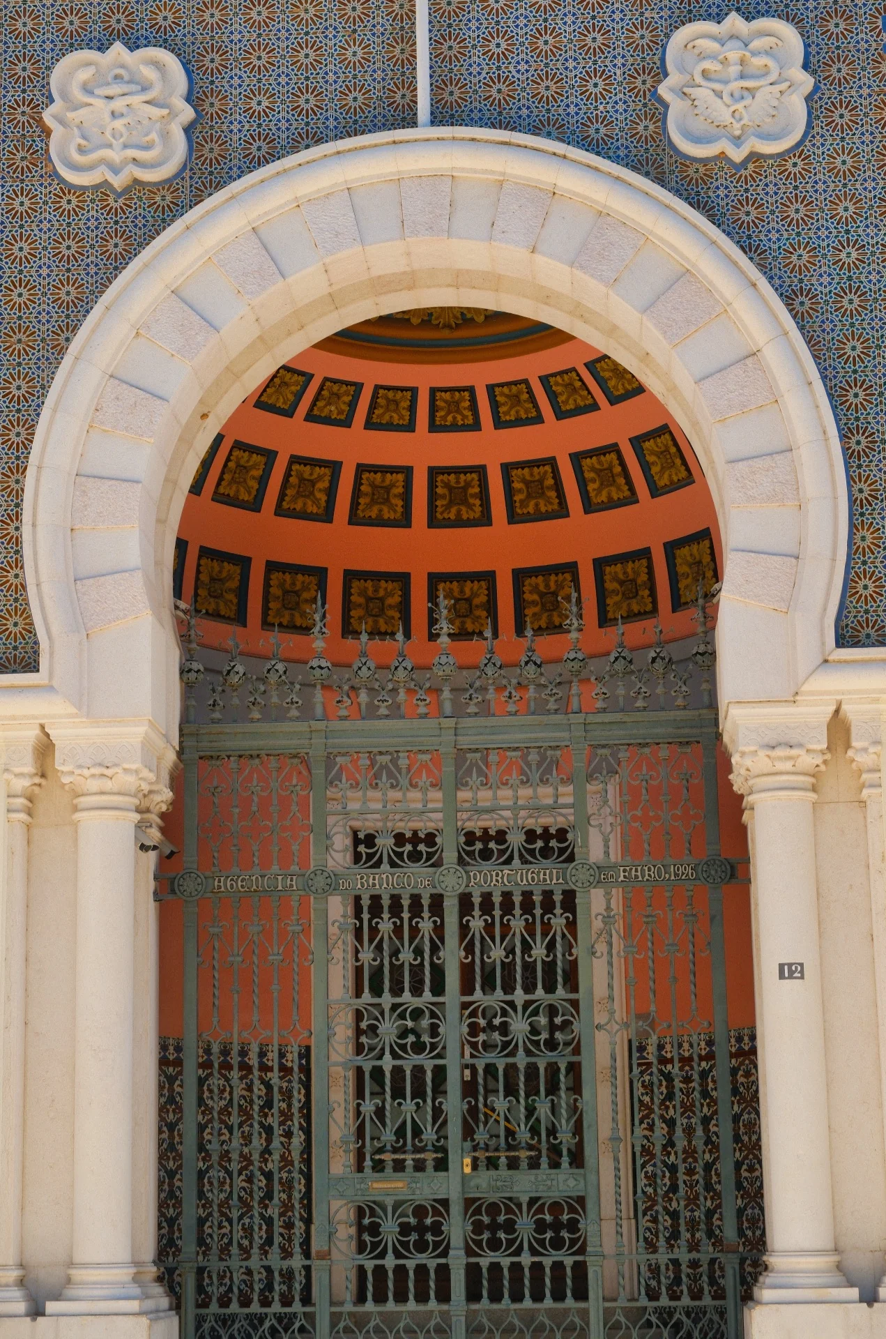 Bank of Portugal building façade in Faro with Neo-Manueline domes and tilework